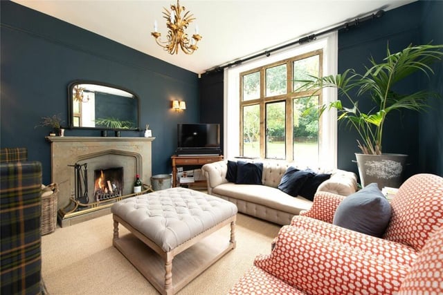 The modern and stylish living room featuring an open fireplace.