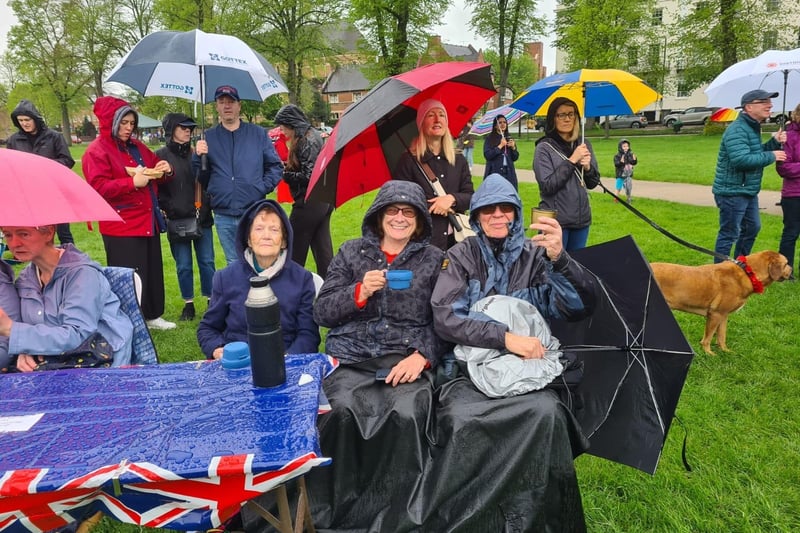 Residents braved the rain to watch the Coronation on the big scree at the Pump Room Gardens on Saturday.