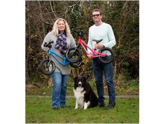 Founders of Kidvelo Bikes Karen and Gary Wood with their dog Chester. Photo supplied