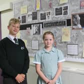 Head boy and head girl, Charlie Millward and Esme Barlow, in front of the display board created in the school to mark the Queen’s passing.