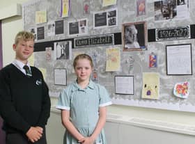 Head boy and head girl, Charlie Millward and Esme Barlow, in front of the display board created in the school to mark the Queen’s passing.