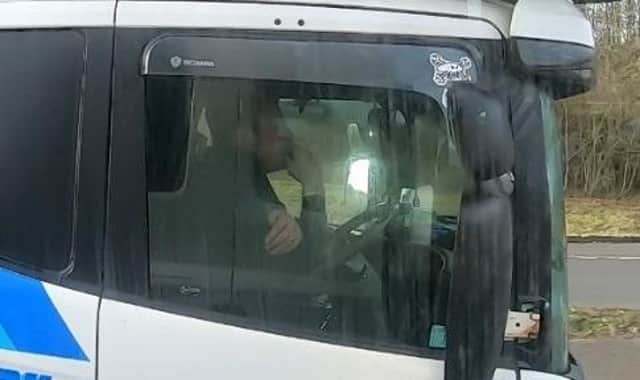 Police officers overtaking this heavily-laden car transporter were shocked to discover the driver was using just one elbow to control the huge vehicle as he travelled along the M40 near Gaydon.