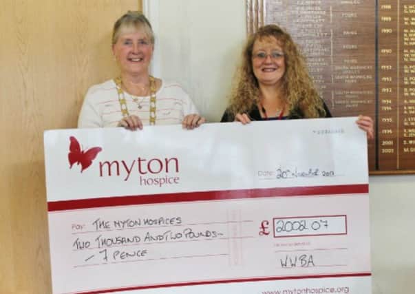 County president Chris Ward hands over the cheque to Rachael Stevens of Myton Hospice