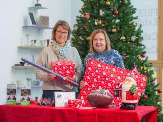It's a wrap - Diana Mansell, Rugby Foodbank project manager and director, and Cllr Heather Timms, Rugby Borough Council portfolio holder for growth and investment, prepare for the launch of the Christmas wrapping service.