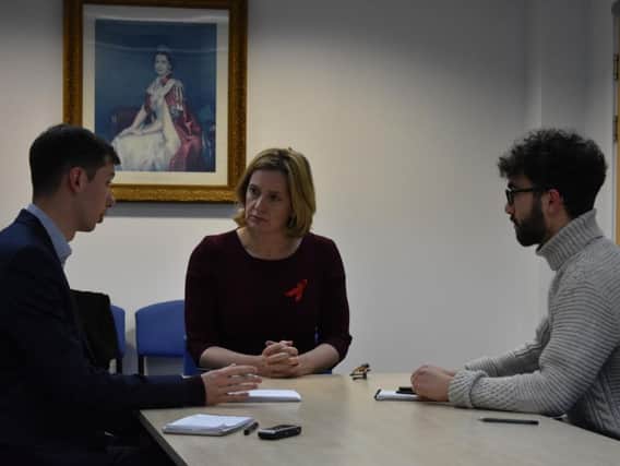 Home Secretary Amber Rudd MP (middle) speaking to journalists about her visit