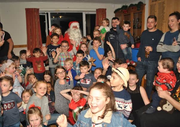 Youngsters enjoying Rugby Golf Club's Christmas party with Santa