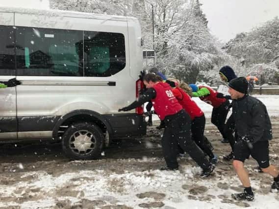Many people have been helping other get out of the snow. Pictured here are the team from British Military Fitness showing how it should be done in Warwick during last years' snowfall.