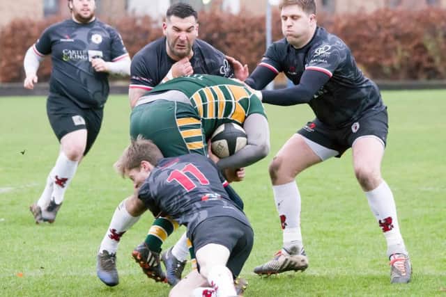 Jonny Ure tackling, with Alex Tansley and Liam Munro