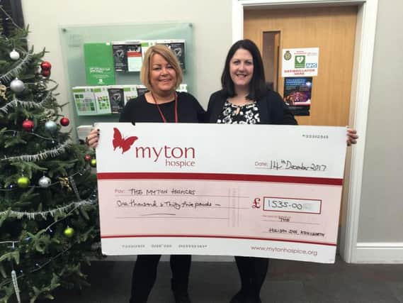 Community fundraiser for Myton Louise Careless (left) receiving a cheque for 1,535 from Holiday Inn Kenilworth's deputy general manager Louise Sheepy