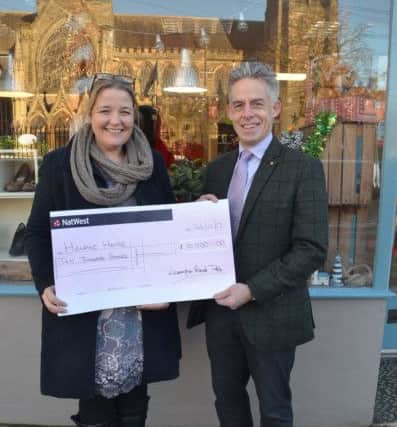 Liannw Kirkman, manager at Helping Hands, with Nick Herd, past chairman of Leamington Round Table.