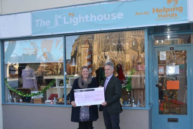 Nick Herd  past chairman of Leamington Round Table presenting  Lianne Kirkman, manager of Helping Hands, a  cheque for Â£10,000.