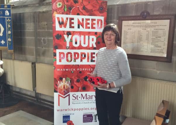Diana Chambers with some of her handmade poppies in St Mary's Church in Warwick.