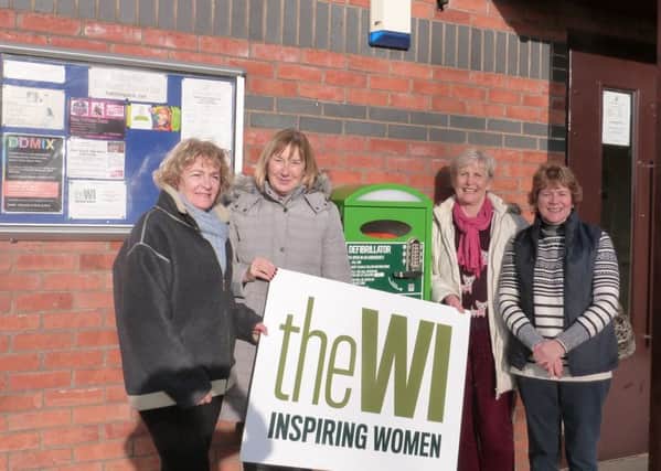 Hatton Park WI members left to right: Patrizia Williams, Veronica Chapman, Tina Davenport, and Lynda Jackson by the newly installed defibrillator.