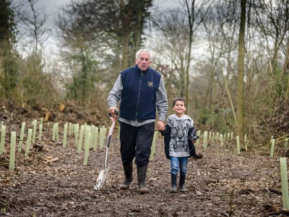 Kenilworth RFC president Willie Whitesmith with his grandson Evan Bahey, who plays for the club's under-6 Minis, in Glasshouse Spinney next to the replanted trees