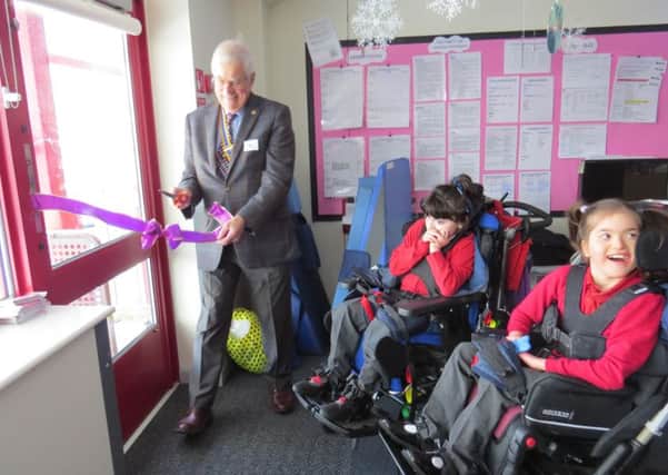 Warwick Rotary Club President John Hibben cutting the ribbon to the outside play area with year 6 pupils from the Lavender class. Photo provided by Warwick Rotary Club.