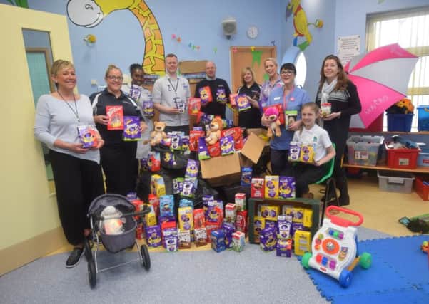 MacGregor Ward staff being presenting armfuls of Easter eggs by the Quattro Recruitment team and representatives of Molly Ollys Wishes.