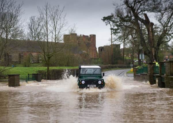 With significant rainfall over Easter Sunday evening and into Easter Monday flood alerts were issued by the Environment Agency for some part of the Midlands on 2 April 2018. A motorist braves the flooded Ford on the A452 at Kenilworth, Warwickshire on 2 April 2018. Photo: Fraser Pithie