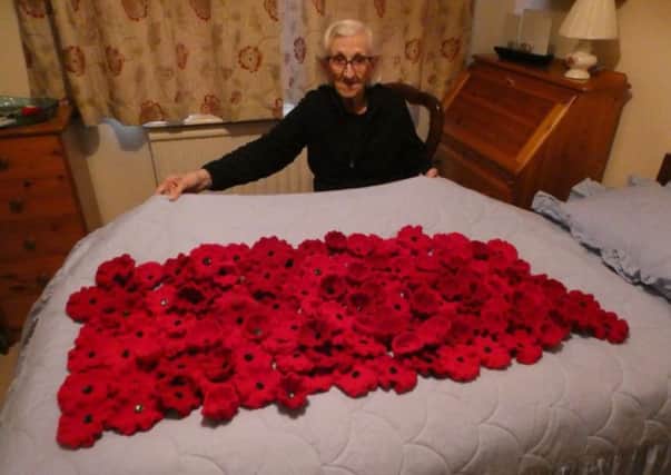 Phyllis Clark with her handmade poppies. Photo provided by Warwick Poppies 2018.