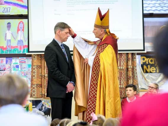 Andrew Morris being formally recognised as headteacher of Burton Green Primary School and All Saints C of E Primary School by the Right Reverend Christopher Cocksworth, Bishop of Coventry