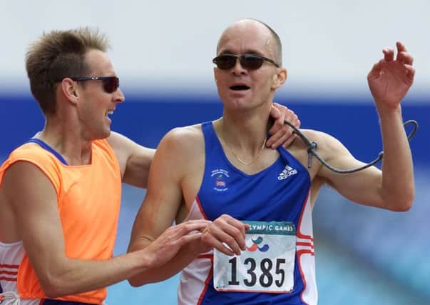 Bob Matthews celebrates with his guide Paul Harwood after winning the 10,000m in Sydney.