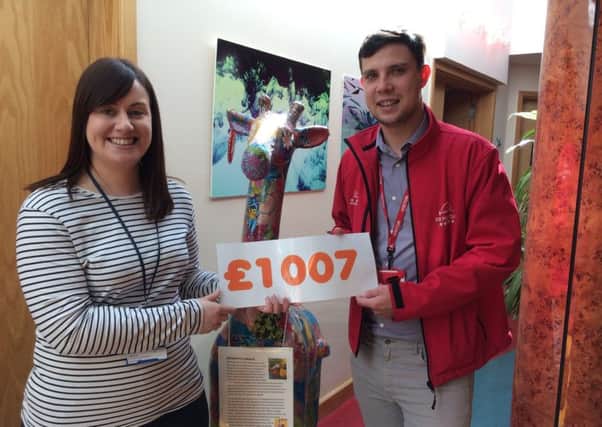 Jenny Howells from Helen & Douglas House receiving the cheque from Adam Walters during his recent visit to the hospice.