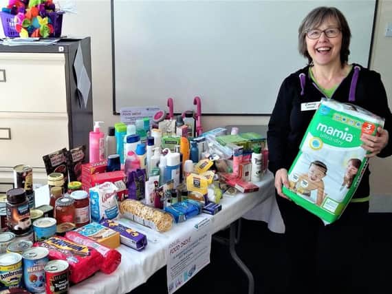 Denise Knight of Curves Kenilworth with just some of the donated items