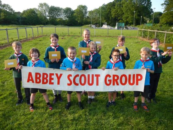 Beavers, Cubs and Scouts from Abbey Scout Group holding tickets for the anniversary raffle