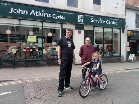 Charlie Cree-Lekarla is pictured with Jason Jackson and Ray Higgins of John Atkins Cycles in Leamington. Charlie is being given a free bicycle by the shop for his cycle challenge.
