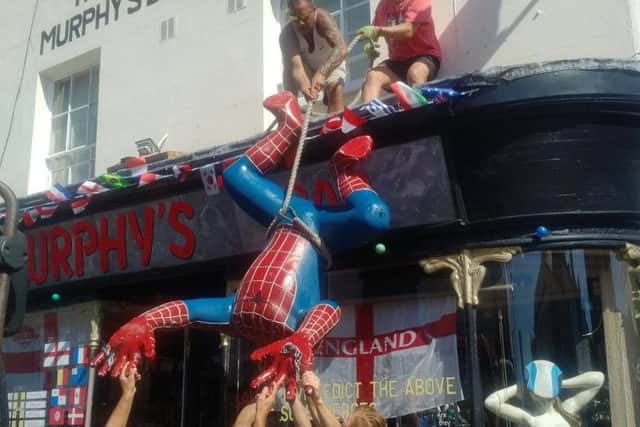 Spider-Man is removed from the front of Murphy's Bar in Leamington.