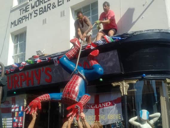 Spider-Man is removed from the front of Murphy's Bar in Leamington.