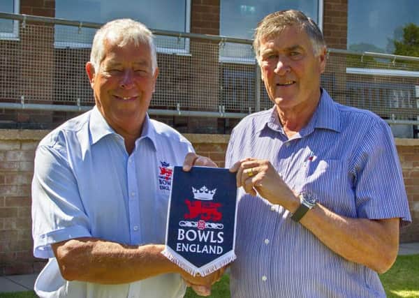 Bowls England president Bill Smith presents a pennant to Lillington captain Colin Daly to mark the hosting of Australia.