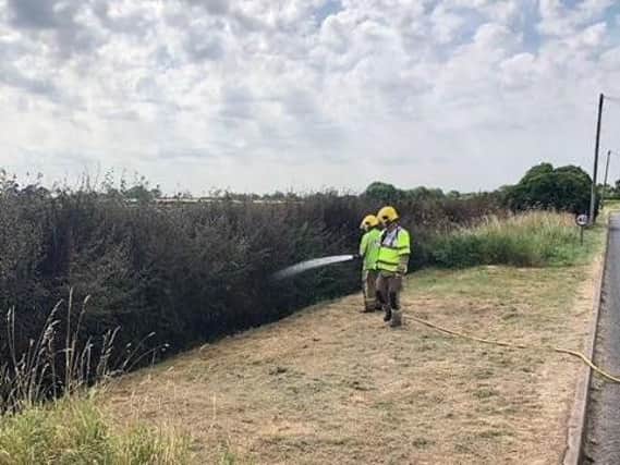 Firefighters putting out a hedgerow fire in Red Lane. Photo: Kenilworth Fire Station