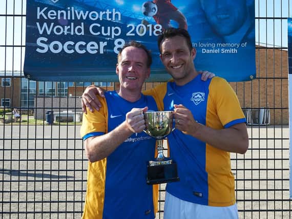 Carl Smith (left) and Riccardo Scimeca (right) holding the winning trophy at the Soccer 8s tournament held on Saturday June 30.