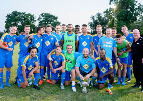 The Leamington squad celebrate with the Tony Horley Cancer Charity Cup. Pictures: Mike Baker