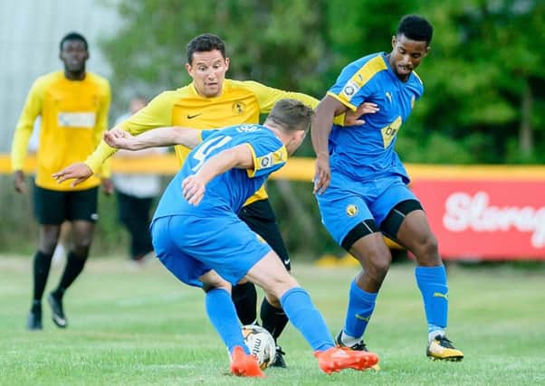 Chekaine Steele challenges for possession with Racing Club Warwick's Sam Beasley. Picture: Mike Baker