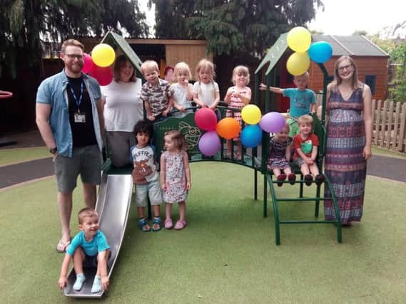 Co-director Mat Bromley (left), assistant manager Sonia Wozencroft (second-left), and co-director Sarah Bromley (right) with children just after the garden party at Castle Nursery.