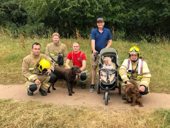 Fire crews with the rescued spaniel (right). Photo: Kenilworth Fire Station