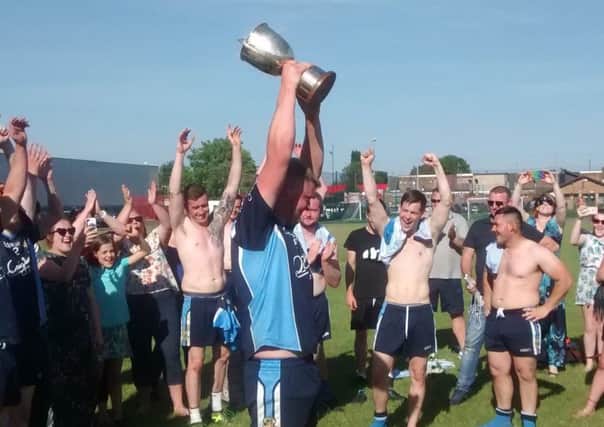 Rugby Gaels captain Lewis Fairgrieves celebrates with supporters as he lifts the Mulligan Cup earlier his season