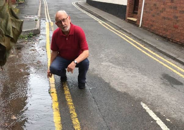 Resident Rick Thompson near the water leak in Chapel Street.