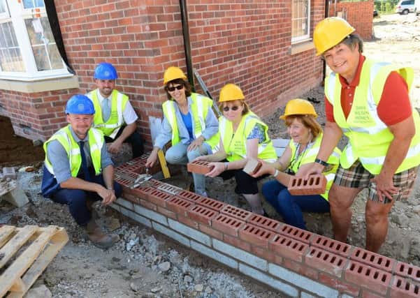 A group of ladies from Long Itchington Womens Institute have been given a hands-on experience of housebuilding at a special event hosted by David Wilson Homes at its local Spinney Fields development.