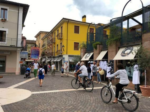 Cycling through picturesque Bardolino's old town.
