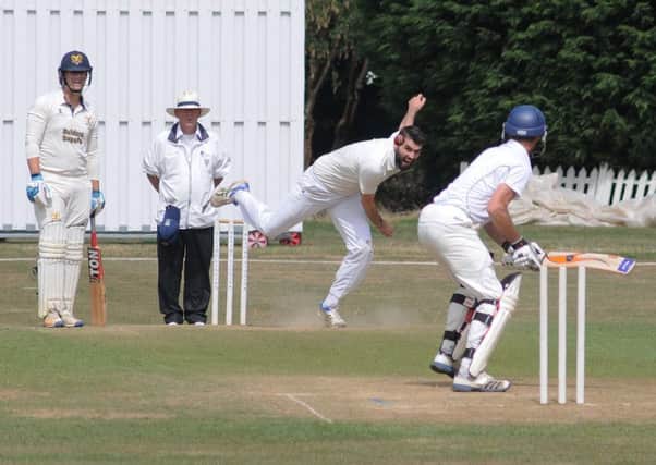 Leamington 2nds bowler Paul Lawrence sends down a delivery to Wardens' Eian Marillier.
