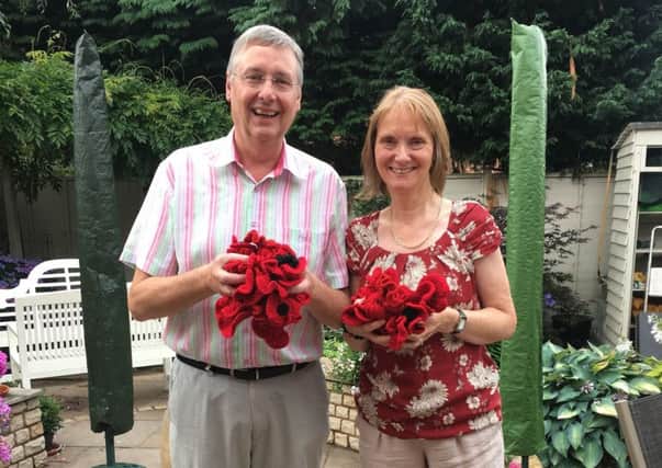 Grahame Edmonds with his cousin Sue and her handmade poppies.