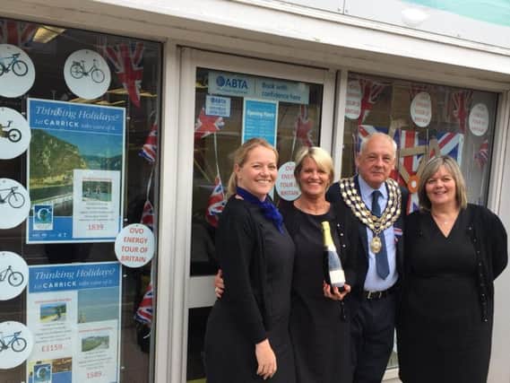 Staff at Carrick Travel with Kenilworth mayor Mike Hitchins receiving their champagne