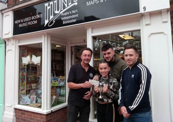 Roger Hunt with granddaughter Abigail, son Lee and Luke Low - winners of the Kelvin Hunt Memorial Trophy, outside Hunts book shop in High Street