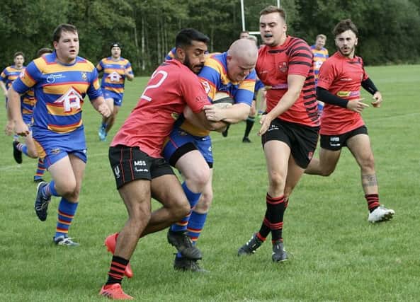 Manny Sidhu and Josh Cooke making a tackle in the 2nds' win on Saturday