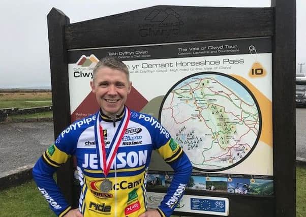 Ryan Ballard with his medal at the top of Horse Shoe Pass in North Wales