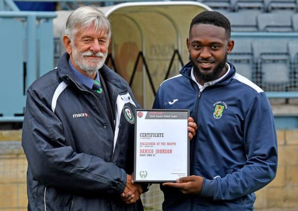Danico Johnson receiving his UCL scorer of the month award for August