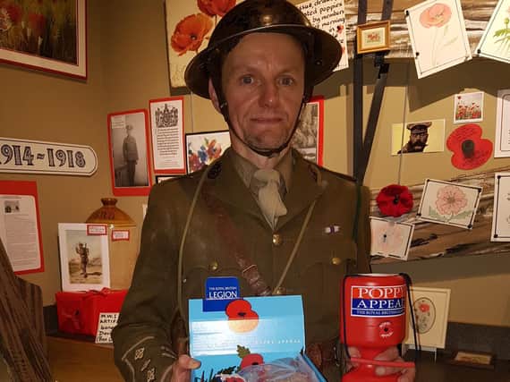 David Crossfield of Talisman Theatre who plays Captain Stanhope in Journey's End next to the poppy display