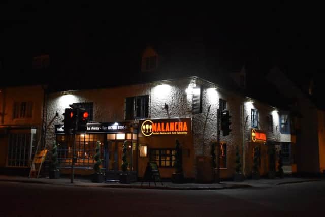 A view of the signs at night at the Dunchurch crossroads.